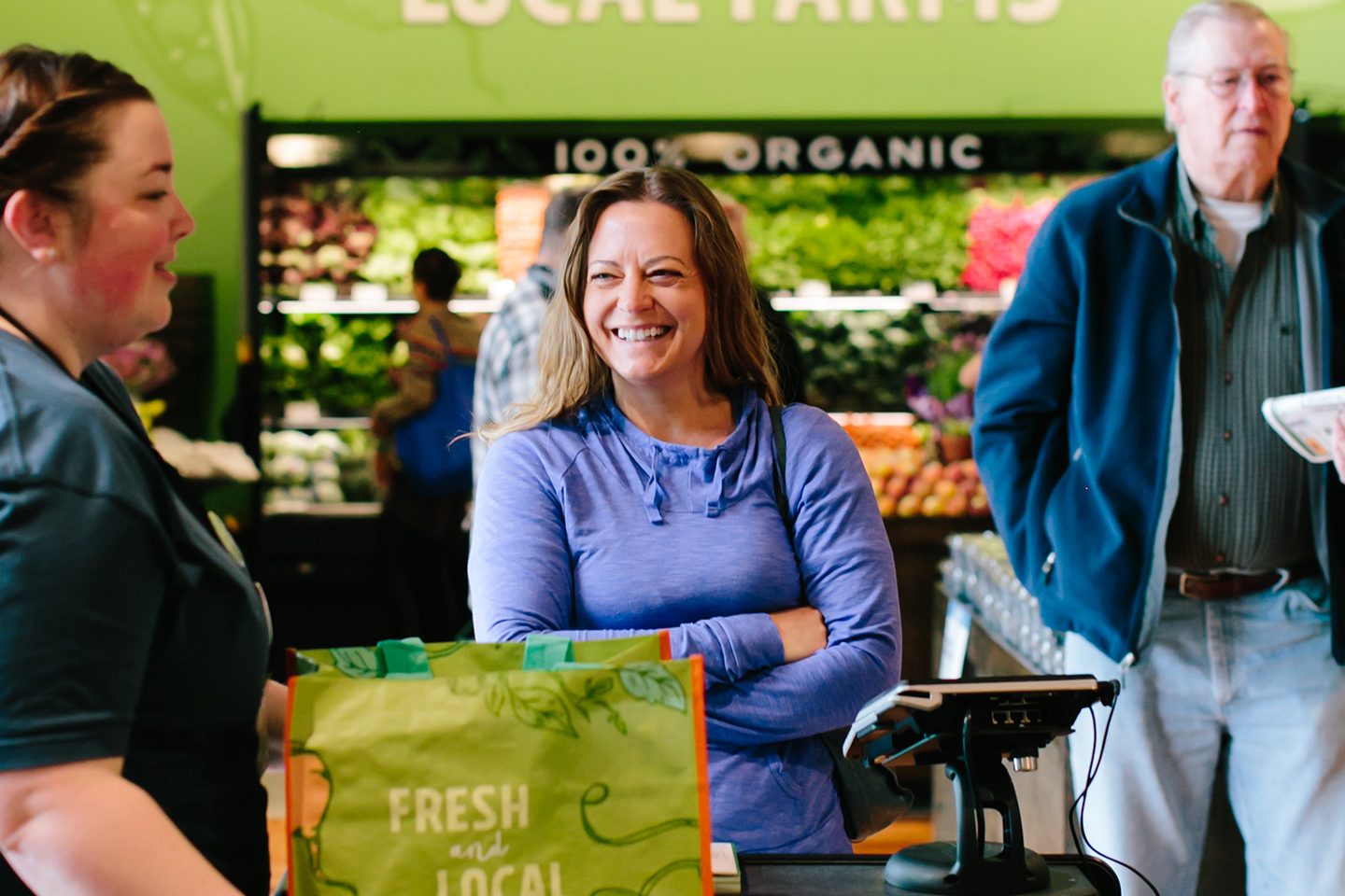 Woman at a New Leaf checkout lane