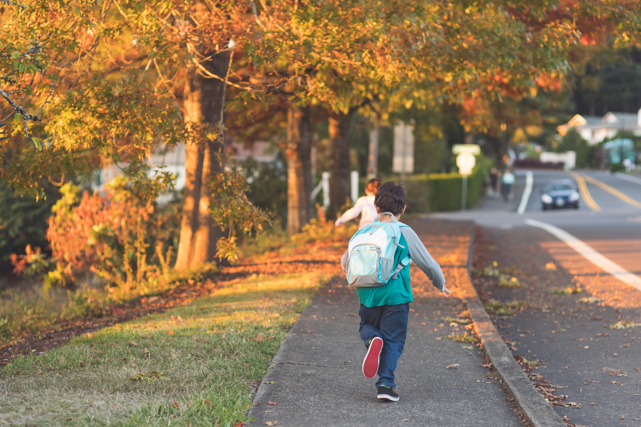 Happy kids running to school with their backpacks on 